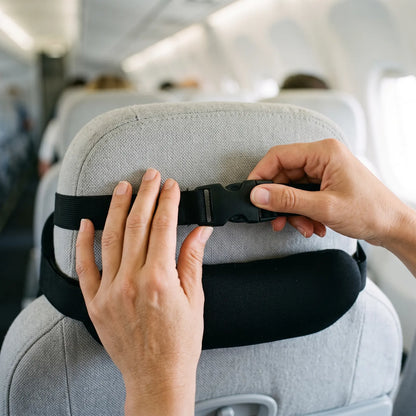 Strap clicks around the seat headrest with a buckle